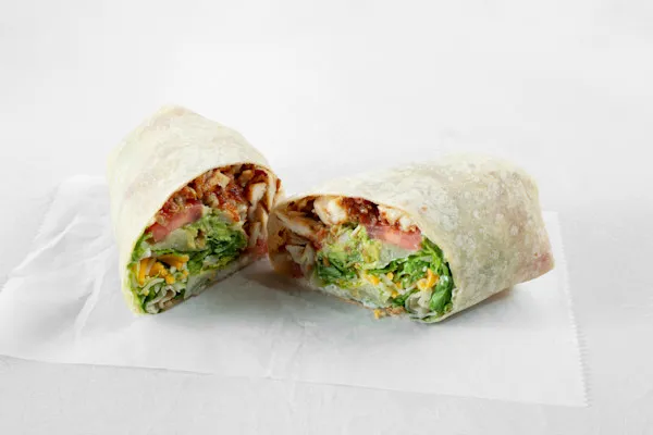 Warm flour tortilla stuffed with panko-battered, antibiotic-free chicken breasts, crispy thick-cut bacon, American yellow cheddar cheese. Layered with freshly sliced avocado, crunchy shredded romaine lettuce, fiery chopped jalapeños, smoky house made chipotle aioli, and sliced tomatoes, this wrap delivers a satisfying kick in every bite.