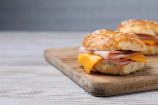 Savory grilled smoked sliced ham, fluffy scrambled eggs, melted American yellow cheddar cheese on a buttery brioche bun.