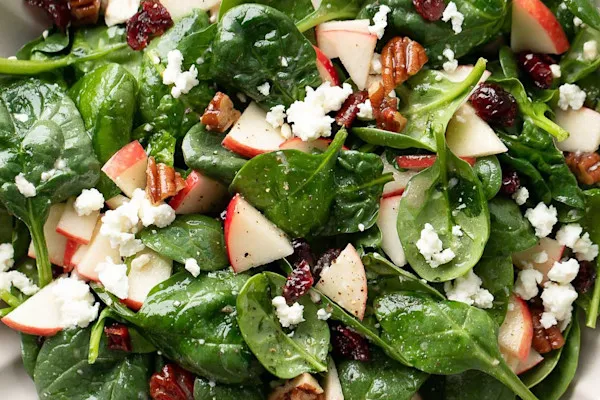 Baby spinach, spring mix, red onions, fuji sliced apples, almonds, goat cheese, champagne vinaigrette dressing on the side.