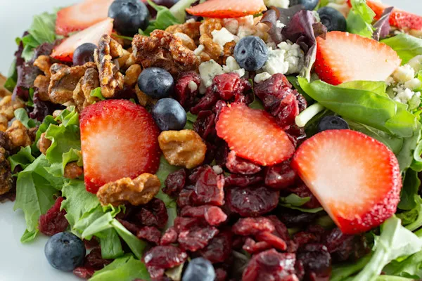 Spring mix, grapes, strawberries, pine nuts, dried cranberries, feta cheese, lemon honey dressing on the side