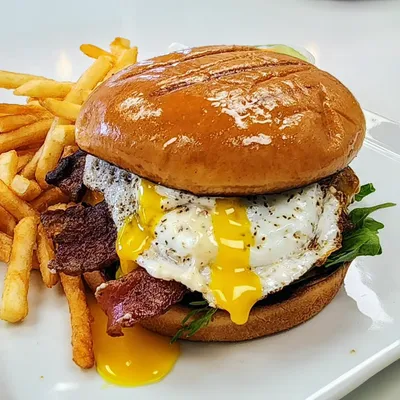 Buttered brioche bun, thick-cut bacon, sunny-side up egg, pepper Jack cheese, spring mix