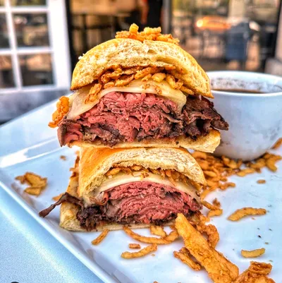 Tender, thinly sliced London broil marinated roast beef with our savory house-made au jus gravy, Boar’s Head melted Swiss cheese, house-fried onions, nestled between two slices of a lightly buttered and toasted hoagie roll