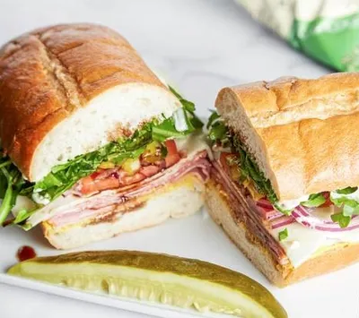 Hoagie Roll, mustard, mayo, ham, salami, mortadella, provolone cheese, tomatoes, red onions, pepperonicis, arugula, balsamic & olive oil