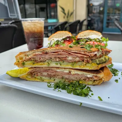Smoked pulled pork, smoked Boar’s Head ham, pickles, Boar’s Head swiss cheese, mayo and mustard on a Hoagie Roll.