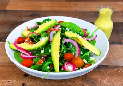 Baby spinach, arugula, pickled red onions, tomatoes, feta cheese, avocado, bacon, cilantro lime vinaigrette dressing on the side.