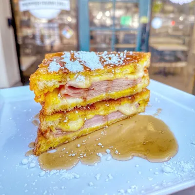 Oven-roasted ham, havarti cheese, mustard, mayo, on egg batter-dipped white bread, pan fried and garnished with powdered sugar!
