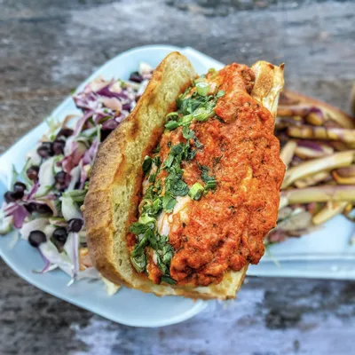 Panko-breaded antibiotic free chicken, house made roasted garlic marinara sauce, melted mozzarella sauce, topped with parmesan cheese, cilantro and green onions on a hoagie roll