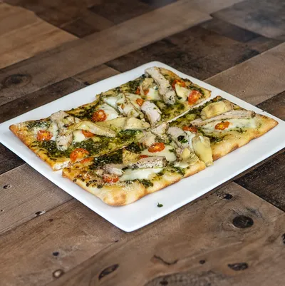 Nut-free pesto sauce, mozzarella cheese, charbroiled chicken breast, heirloom tomatoes.