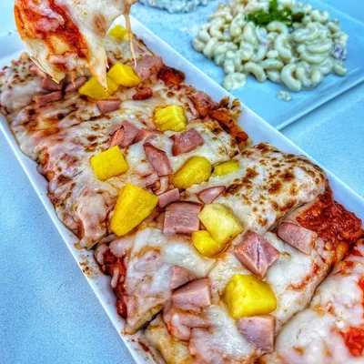 Crispy flatbread topped with sweet pineapple, savory ham, melted mozzarella cheese, and a zesty house-made marinara sauce